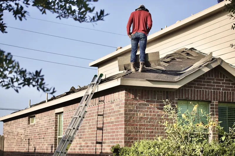 Professional roofer working on a residential roof in North Vernon